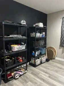 After — two black shelving units holding clear labeled bins above a clear floor, catch-all room in Union, KY