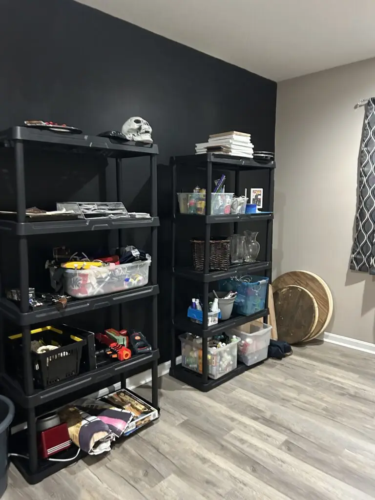 After — two black shelving units holding clear labeled bins above a clear floor, catch-all room in Union, KY