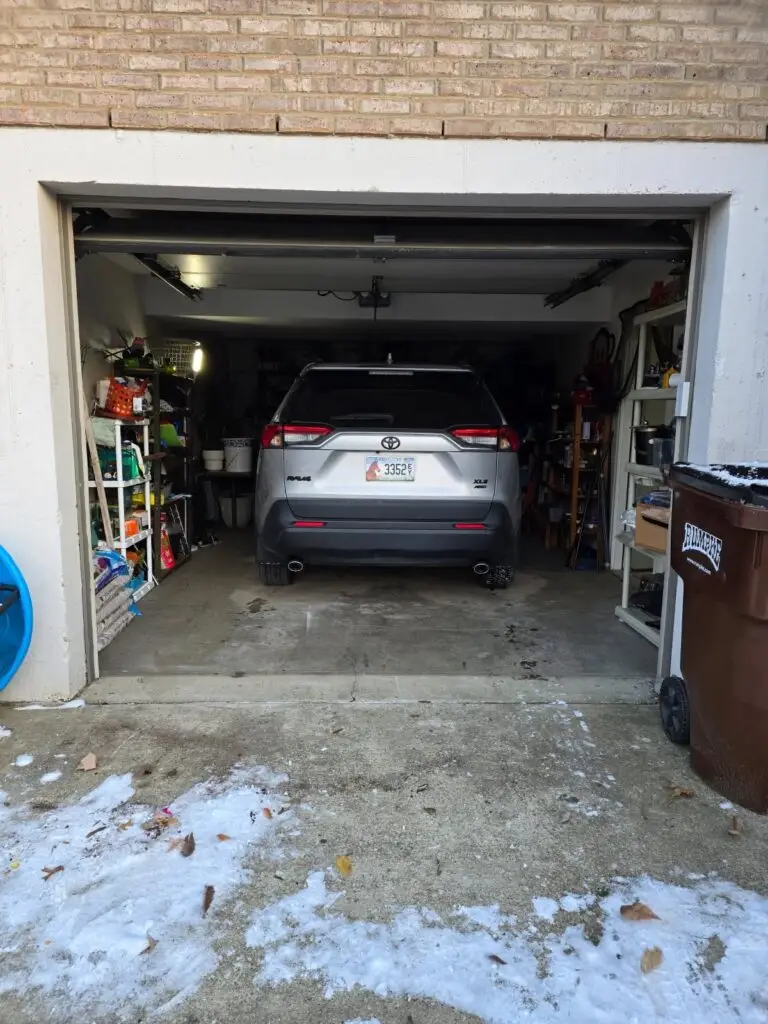 After — a car parked inside the garage with the shelving clear on both sides, garage in Park Hills, KY