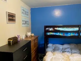 After — a clear dresser top with a toy chest and wall art above, kids bedroom in Cincinnati, OH