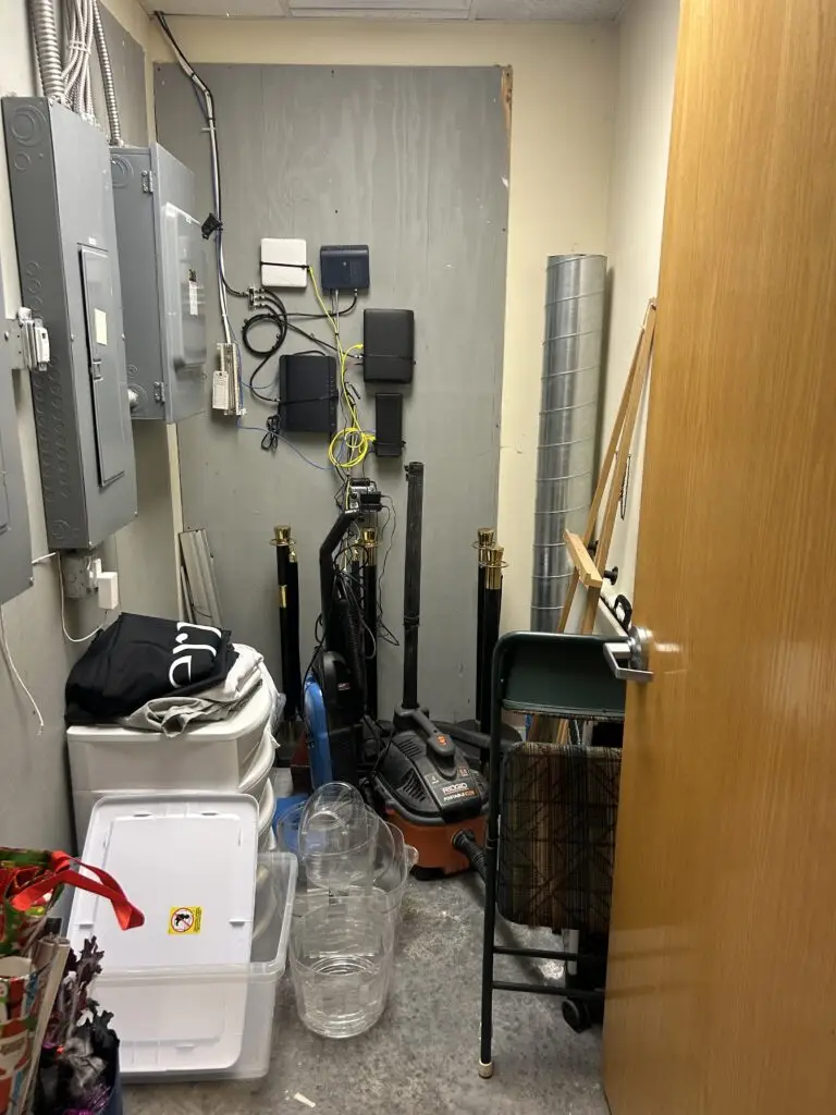 After — rope stands lined against the wall, stacked white drawers and clear bins with a clear floor, med spa storage closet in Crescent Springs, KY