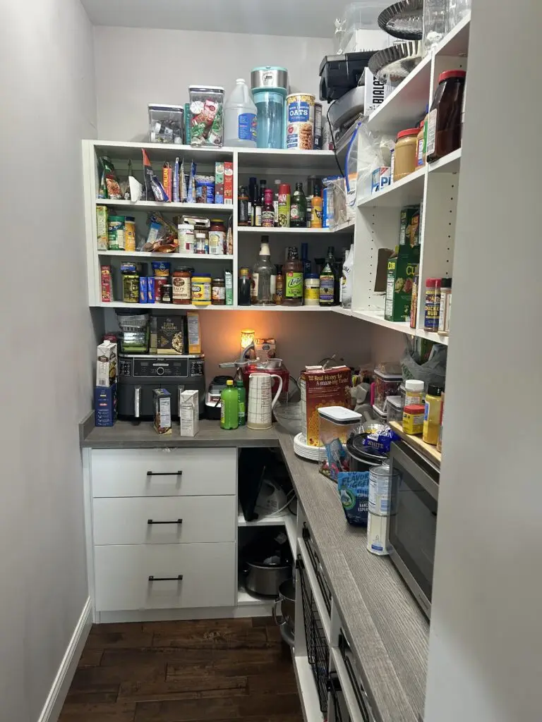 Before — crowded shelves with the counter covered in packets, bottles and small appliances, walk-in pantry in Demossville, KY